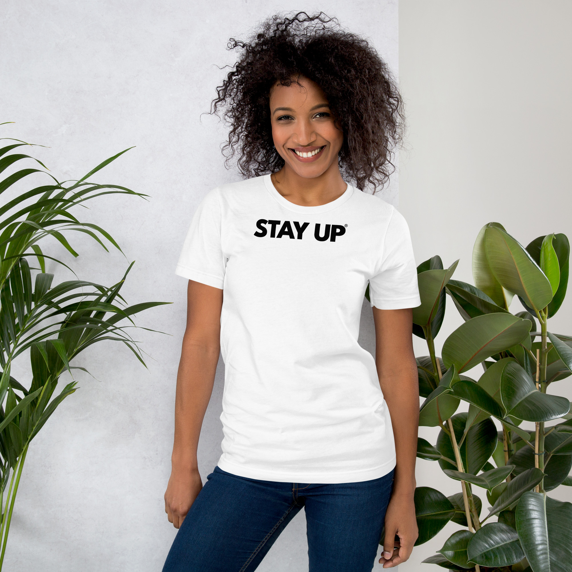 Model wearing the Stay Up t-shirt with bold logo in light colors, highlighting the soft cotton and streetwear style.